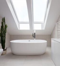 A bathtub underneath a skylight