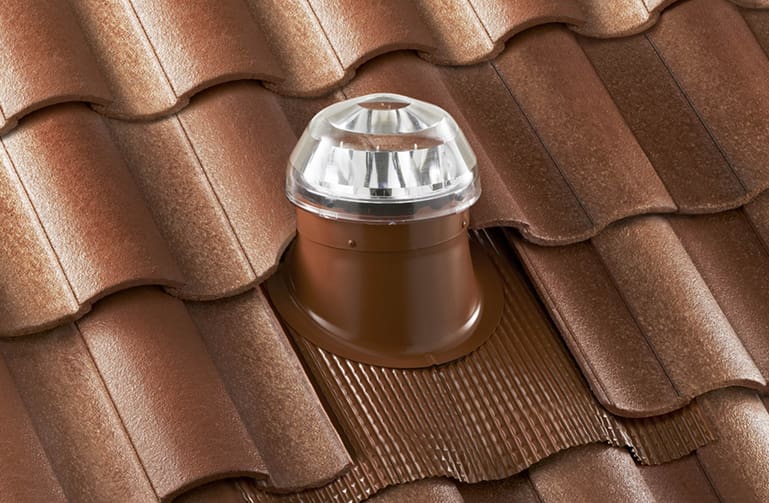 A solatube tubular skylight installed on a rolled asphalt roof