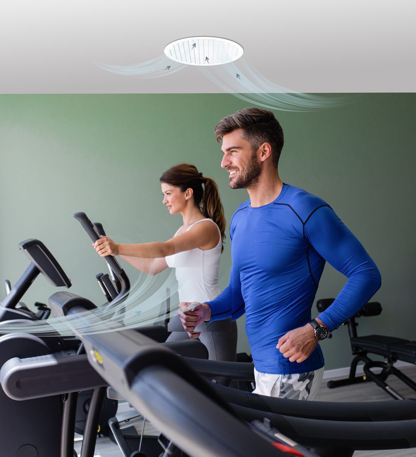 A couple on treadmills with an EPS Focus fan above them