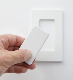 Photograph of a hand holding the remote control for the EPS Focus