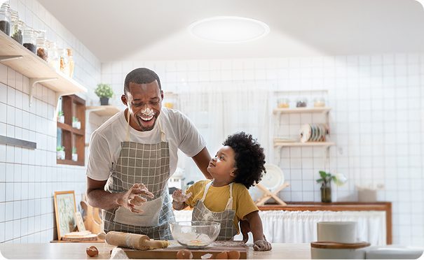 Father and son in the kitchen beneath a solatube tubular skylight