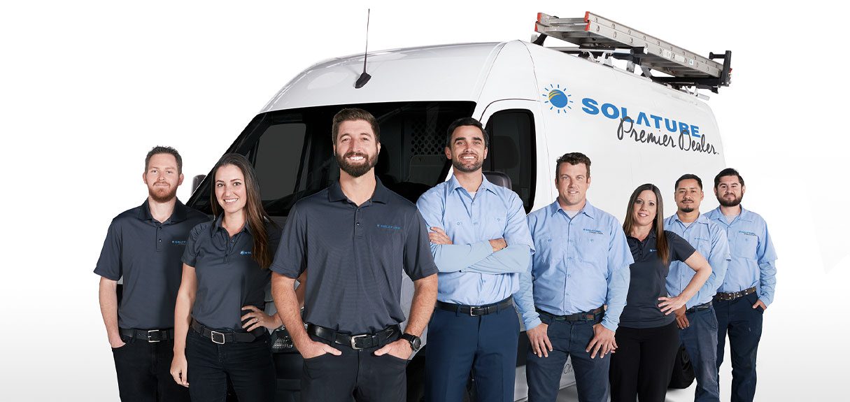 Premier dealer team in front of the van