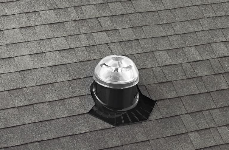A solatube dome on a shingled roof