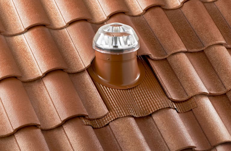 A solatube dome installed on a spanish tile roof